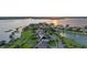 Scenic aerial view of waterfront houses with private boat docks on a serene lake at sunset at 16086 Johns Lake Overlook Dr, Winter Garden, FL 34787