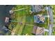 Stunning aerial view of lakefront property featuring a private dock, lush lawn, and an inviting pool area at 16086 Johns Lake Overlook Dr, Winter Garden, FL 34787
