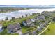 Aerial view showcasing lakefront neighborhood with beautiful landscaping and tranquil pond at 16086 Johns Lake Overlook Dr, Winter Garden, FL 34787