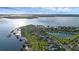 Scenic aerial view of waterfront homes, docks, and the vast, serene lake and surrounding neighborhood at 16086 Johns Lake Overlook Dr, Winter Garden, FL 34787