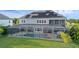 Rear exterior view of a house with a screened-in pool and solar panels at 16086 Johns Lake Overlook Dr, Winter Garden, FL 34787