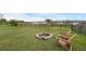 Relaxing backyard featuring a fire pit and chairs on a grassy lawn near the lake at 16086 Johns Lake Overlook Dr, Winter Garden, FL 34787