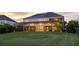 A screened-in backyard featuring solar panels and string lights at 16086 Johns Lake Overlook Dr, Winter Garden, FL 34787