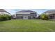 Large backyard with a screened-in patio, offering ample space for outdoor enjoyment at 16086 Johns Lake Overlook Dr, Winter Garden, FL 34787