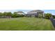 Large grassy backyard with a screened-in patio, perfect for outdoor activities and entertaining at 16086 Johns Lake Overlook Dr, Winter Garden, FL 34787