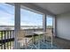 Outdoor balcony featuring a table and chairs with peaceful water views at 16086 Johns Lake Overlook Dr, Winter Garden, FL 34787