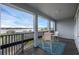 Balcony view with seating and a black railing overlooking a lake with boats and clear blue skies at 16086 Johns Lake Overlook Dr, Winter Garden, FL 34787