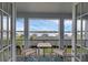 Enjoy serene water views from this lovely balcony with seating for two at 16086 Johns Lake Overlook Dr, Winter Garden, FL 34787