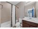 Bathroom with a shower-tub, vanity with storage and a mirror at 16086 Johns Lake Overlook Dr, Winter Garden, FL 34787
