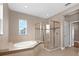 Large bathroom featuring soaking tub and glass-enclosed shower at 16086 Johns Lake Overlook Dr, Winter Garden, FL 34787