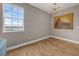 Bright room featuring beautiful wood floors, a modern light fixture, and lion artwork at 16086 Johns Lake Overlook Dr, Winter Garden, FL 34787