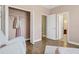 This bedroom showcases closet storage and access to the ensuite bathroom with wood-look floors and light pink walls at 16086 Johns Lake Overlook Dr, Winter Garden, FL 34787