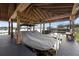 Private boathouse featuring a covered boat dock with benches, lights, and space for lakeside enjoyment at 16086 Johns Lake Overlook Dr, Winter Garden, FL 34787