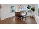 Dining room area offering many windows, hardwood floors, and a pendant light fixture at 16086 Johns Lake Overlook Dr, Winter Garden, FL 34787
