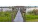 Private boat dock with boat house access, perfect for waterfront living on the serene lake at 16086 Johns Lake Overlook Dr, Winter Garden, FL 34787