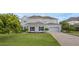 Two-story home featuring a driveway, lawn and a two-car garage at 16086 Johns Lake Overlook Dr, Winter Garden, FL 34787
