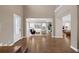 Bright and airy foyer with high ceilings, wood floors, and views into the living spaces at 16086 Johns Lake Overlook Dr, Winter Garden, FL 34787