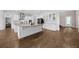 Spacious kitchen with white cabinetry, large island, modern appliances, and wood flooring at 16086 Johns Lake Overlook Dr, Winter Garden, FL 34787