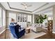 Comfortable living room with large windows and a decorative bookcase at 16086 Johns Lake Overlook Dr, Winter Garden, FL 34787