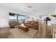 Living room boasts an open layout with wood floors, a view of the modern kitchen, and outdoor scenery at 16086 Johns Lake Overlook Dr, Winter Garden, FL 34787