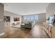 Spacious living room with large windows, ample seating, and hardwood floors at 16086 Johns Lake Overlook Dr, Winter Garden, FL 34787