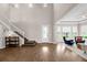 Spacious living room with hardwood floors, staircase and ample natural light at 16086 Johns Lake Overlook Dr, Winter Garden, FL 34787