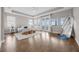 Bright main bedroom with hardwood floors, French doors, and a tray ceiling at 16086 Johns Lake Overlook Dr, Winter Garden, FL 34787