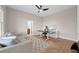 Office space, with hardwood floors, a modern ceiling fan and a view into an en suite bathroom at 16086 Johns Lake Overlook Dr, Winter Garden, FL 34787