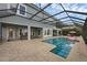 Screened in backyard pool with lounge area and pool table at 16086 Johns Lake Overlook Dr, Winter Garden, FL 34787