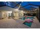 Relaxing screened-in pool with lights and ample outdoor seating at 16086 Johns Lake Overlook Dr, Winter Garden, FL 34787