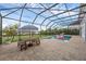 Backyard featuring an enclosed pool with a flamingo float, seating, and lake view at 16086 Johns Lake Overlook Dr, Winter Garden, FL 34787