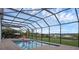Backyard pool with screen enclosure overlooking a waterfront view at 16086 Johns Lake Overlook Dr, Winter Garden, FL 34787