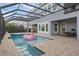 Screened in pool area, featuring a flamingo float, outdoor lighting, and patio seating at 16086 Johns Lake Overlook Dr, Winter Garden, FL 34787