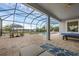 Spacious screened pool patio with table, lounge seating, bar, and view of the lake at 16086 Johns Lake Overlook Dr, Winter Garden, FL 34787