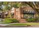 Stunning brick restaurant exterior with outdoor seating, lush landscaping, and inviting entrance, perfect for dining and gathering at 16086 Johns Lake Overlook Dr, Winter Garden, FL 34787