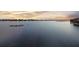 Calm lake and waterfront view with an orange sunset sky at 16086 Johns Lake Overlook Dr, Winter Garden, FL 34787
