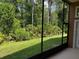 Manicured lawn and lush greenery viewed from screened lanai at 2143 Autumn View Dr, Orlando, FL 32825