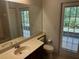 Neutral bathroom with large mirror, granite countertop, and walkout access at 2143 Autumn View Dr, Orlando, FL 32825