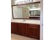 Vanity with a mirror in bathroom with tile floors, wood cabinets and granite counters at 2143 Autumn View Dr, Orlando, FL 32825