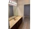 Bathroom with a double vanity sink and a large mirror, plus a door leading to a shower and bathtub area at 2143 Autumn View Dr, Orlando, FL 32825