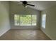 Bright bedroom featuring vaulted ceilings, tile floors, and an oversized window overlooking nature at 2143 Autumn View Dr, Orlando, FL 32825