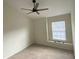 A bright bedroom featuring neutral carpeting, a ceiling fan, and a window for natural light at 2143 Autumn View Dr, Orlando, FL 32825