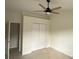 Neutral bedroom with ceiling fan and a closet at 2143 Autumn View Dr, Orlando, FL 32825