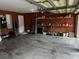Spacious garage with painted walls, concrete floor and shelving for storage at 2143 Autumn View Dr, Orlando, FL 32825