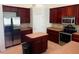 Kitchen featuring stainless steel appliances, dark wood cabinetry, and large island at 2143 Autumn View Dr, Orlando, FL 32825