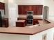 Kitchen featuring stainless steel appliances, dark wood cabinetry, and ample counter space at 2143 Autumn View Dr, Orlando, FL 32825
