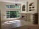 Bright living room with large windows, tile flooring, and fireplace with unique built-in shelving at 2143 Autumn View Dr, Orlando, FL 32825