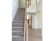 Carpeted staircase with wooden banister at 2143 Autumn View Dr, Orlando, FL 32825