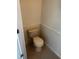 Toilet in a neutral toned water closet with tile floor at 2143 Autumn View Dr, Orlando, FL 32825