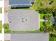Aerial view of backyard with two palm trees, an outdoor seating area, and well manicured landscaping at 2227 Blue Salvia St, Clermont, FL 34711